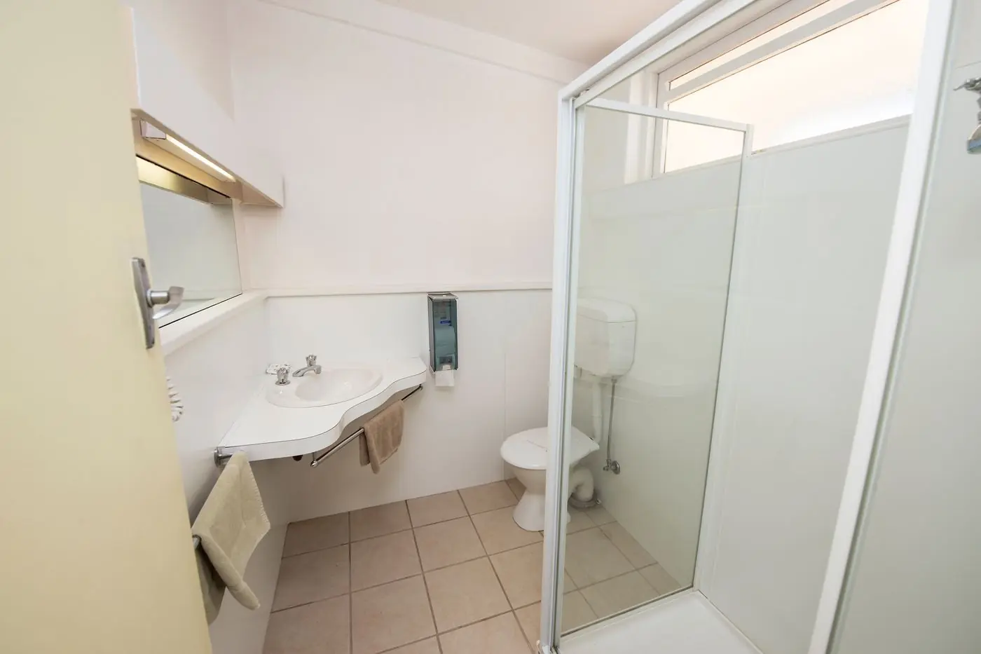 The ensuite bathroom, with a shower, vanity and toilet