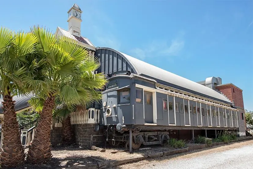 The heritage railway carriage and clock tower at the Pioneer Settlement, Swan Hill