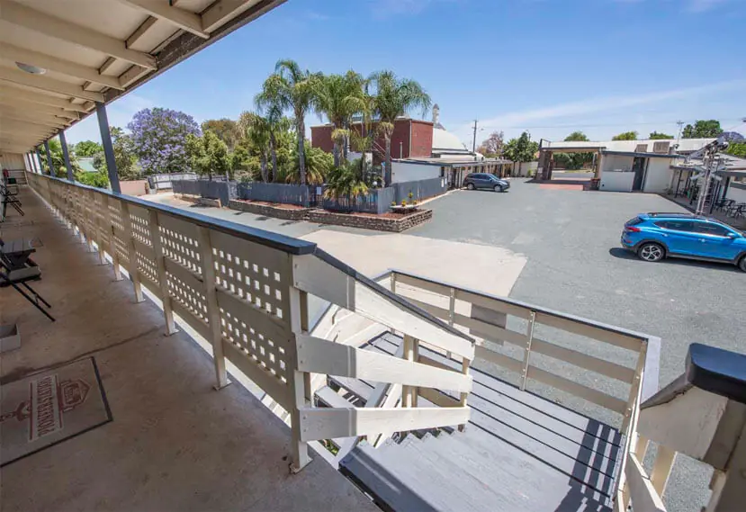 The upstairs verandah and timber staircase overlooking the motel car park